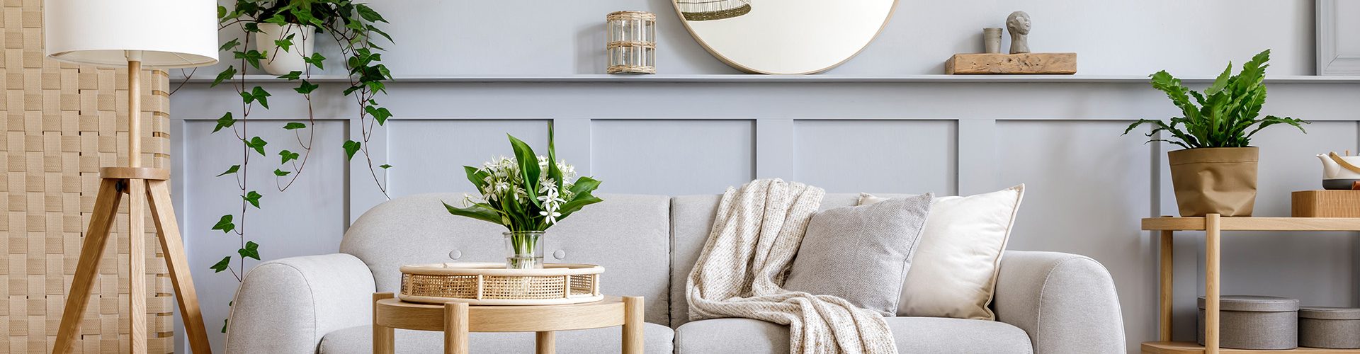 1.scandinavian-living-room-interior-with-design-grey-sofa-wooden-coffee-table-tropical-plants-shelf-mirror-furniture-plaid-pillow-teapot-book-elegant-personal-accessories-home-decor